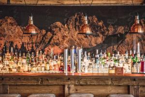 a bar with a lot of bottles of alcohol at Kitzhof Mountain Design Resort 4 Sterne Superior in Kitzbühel