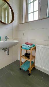 a bathroom with a sink and a mirror at Gästehaus Ambiente am Kurpark in Bad Sooden-Allendorf