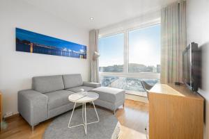 a living room with a couch and a tv at Frogner House - Lagårdsveien 115 in Stavanger