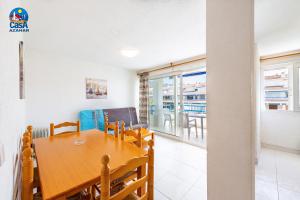 comedor y sala de estar con mesa y sillas en Apartamentos Poblado Marinero Casa Azahar, en Alcossebre