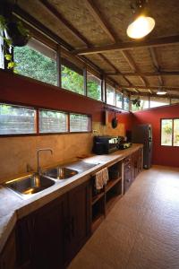 a kitchen with two sinks and a counter with windows at Fisheye Villa in El Nido