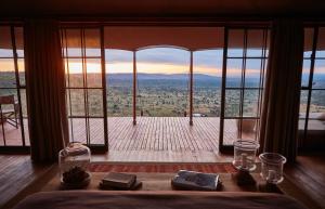 a room with a large window with a view at Loisaba Lodo Springs in Tura