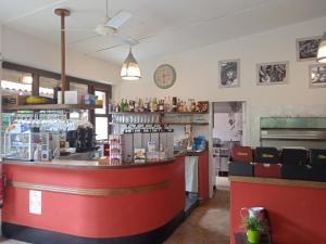 a bar in a restaurant with a red counter at Mobile home Comfort Ameglia - Including airco - Camping River- 326- 6 pers in Ameglia