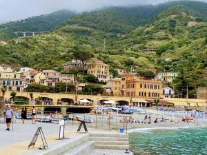 a group of people on a beach near the water at Mobile home Comfort Ameglia - Including airco - Camping River- 326- 6 pers in Ameglia