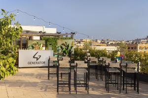 a dining area with tables, chairs and umbrellas at Generator Rome in Rome