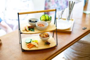 een dienblad met drie niveaus eten op een tafel bij Sishaus Hostel in Graz