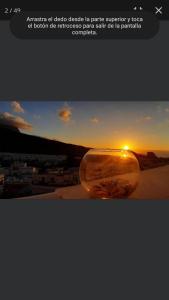 a picture of a sunset in a glass vase at Apartamentos Harizan in Agaete
