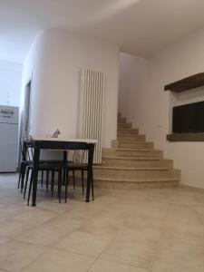 a black table in a room with stairs at Agriturismo Lo Scoiattolo in Ronciglione