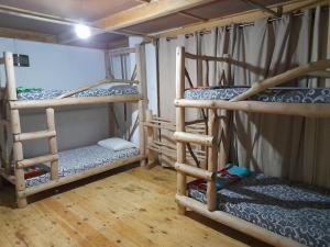 a room with three bunk beds in a room at Kingfern in Nuwara Eliya