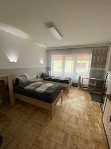 a bedroom with two beds and a large window at Ferienwohnung H&M Immobilien Hettstedt 2 in Hettstedt