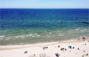 a group of people on a beach near the ocean at 2 Bedroom Cozy Apartment In Kolobrzeg in Kołobrzeg