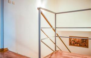 a shelf in a room with a painting on the wall at 2 Bedroom Cozy Apartment In Kolobrzeg in Kołobrzeg