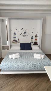 a bedroom with a large bed with two pillows at Duomo Rooms Cefalù in Cefalù