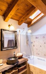 a bathroom with a sink and a shower with a mirror at Casa Rural LA LAVANDA Lugar de ensueño en la Alcarria in El Olivar