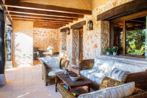 a patio with a couch and chairs and a table at Casa Rural LA LAVANDA Lugar de ensueño en la Alcarria in El Olivar