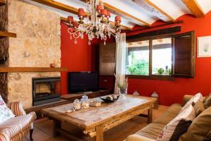 a living room with a wooden table and a fireplace at Casa Rural LA LAVANDA Lugar de ensueño en la Alcarria in El Olivar