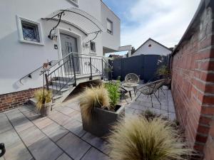 a patio with stairs and plants in front of a house at Pension Zweite Heimat in Wörth am Main