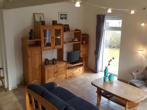 una sala de estar con un sofá y una mesa en Mees, en Hollum