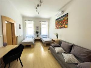 a living room with a couch and a table at Viktorija City Center Apartment in Ljubljana