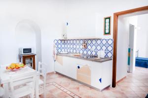 a kitchen and dining room with a table and a counter at Emerald's Resort - Rachele in Conca dei Marini