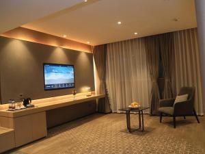a hotel room with a television on a wall at Skylight In-Terminal Hotel in Addis Ababa