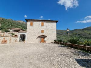a large stone building with a large driveway at CASALE DEI PRIORI in Rocca Massima