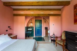a bedroom with a bed and a blue door at Palazzo Previtera in Linguaglossa