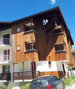 a building with a car parked in front of it at Les Terrasses de la Foux Coquet studio 100m Labrau 4 couchages in La Foux