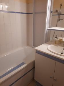 a bathroom with a white tub and a sink at Les Terrasses de la Foux Coquet studio 100m Labrau 4 couchages in La Foux