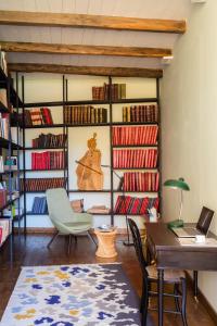 a room with a desk and chairs and books at Palazzo Previtera in Linguaglossa