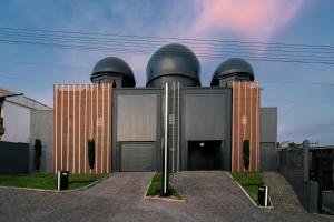 a building with three domes on top of it at Drops Motel Porto Alegre in Porto Alegre