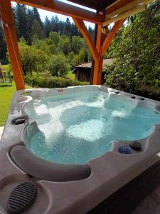 a hot tub in a gazebo at Kuca za odmor Lujzijana in Skrad