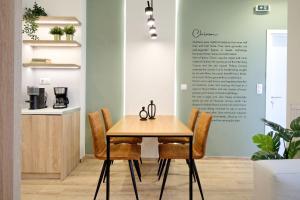 una sala da pranzo con tavolo e sedie in legno di Eos Residence ad Atene