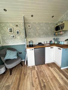 a kitchen with a sink and a couch in a room at The Hazel Hut in Westport