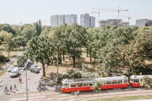 two red and white trolley cars in a park at Central Design-Apartment next to Belvedere Castle in Vienna