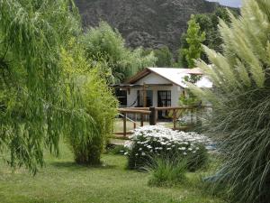 a small house in the middle of a garden at Cabañas Terramaría de Potrerillos in Potrerillos
