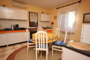 a kitchen with a table and chairs and a table and a table and a kitchen at Holiday house with a parking space Presika, Labin - 7391 in Labin