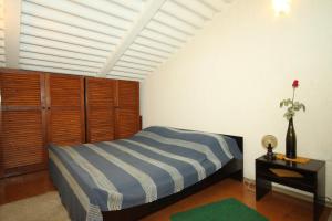a bedroom with a bed and a table with a flower at Apartments with a parking space Medulin - 7328 in Medulin