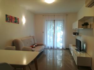 a living room with a couch and a television at Apartments with a parking space Presika, Labin - 7390 in Labin