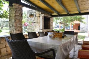 a table and chairs on an outdoor patio at Family friendly house with a swimming pool Guran, Central Istria - Sredisnja Istra - 7373 in Vodnjan