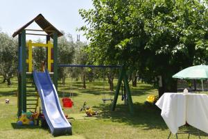 a playground with a slide and a play structure at Family friendly house with a swimming pool Guran, Central Istria - Sredisnja Istra - 7373 in Vodnjan