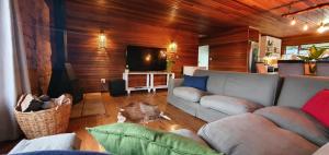 a living room with a couch and a tv at Summer Villa in Mossel Bay