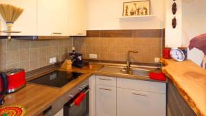 a kitchen with a sink and a counter top at Haus der 5 Kontinente in Böbrach +37 photos
