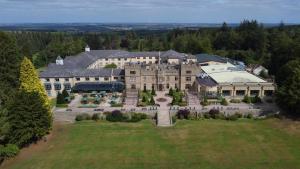 an aerial view of a large building on a field at Slaley Hall Hotel, Spa & Golf Resort in Slaley