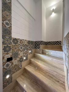 a sauna with tiles on the wall and wooden stairs at GianLuis Luxury Suites in Fasano
