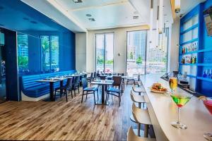 a restaurant with blue walls and tables and chairs at Ocean View 2BR 2BTH Hallandale Beach Miami Ft Lauderdale in Hallandale Beach