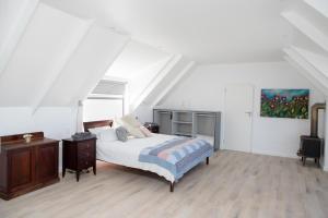 a bedroom with a bed and a painting on the wall at The Duinhuis Yzerfontein in Yzerfontein