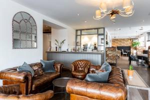 una sala de estar con muebles de cuero y un bar en The Gannet Inn, en St Ives