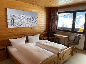 a bedroom with two beds in a room with a window at Chalet H Montafon in Gaschurn