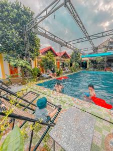 a group of children playing in a swimming pool at Tam Coc Sunrise Homestay in Ninh Binh
